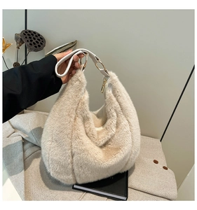 Detailed shot of cream faux fur tote bag with white leather handle and gold hardware links