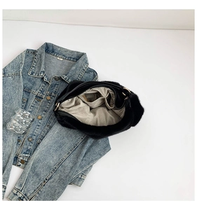 Détail de l'intérieur d'un grand sac à main en fausse fourrure noire avec doublure grise