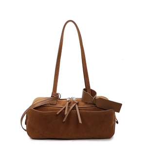 Brown matte suede shoulder bag with dual zipper tassels and cylindrical design
