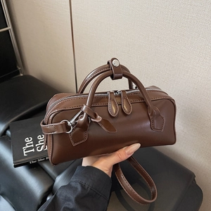 Deep brown matte leather Boston bag with top handles and adjustable shoulder strap