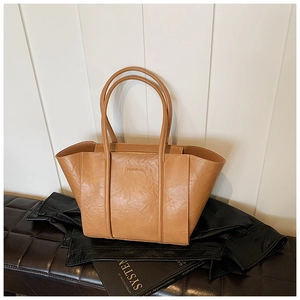 Detail of light brown tote bag with wrinkled leather texture and Fashion embossing