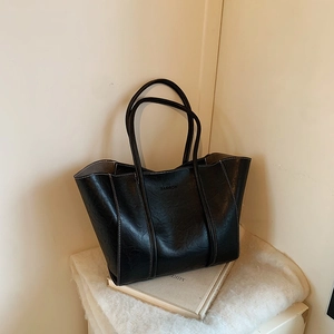 Retro black faux leather tote bag with FASHION embossing for stylish daily commuting