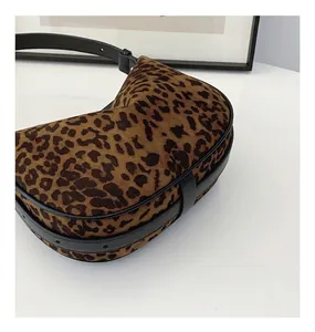 Detailed close-up of retro leopard print crossbody bag with premium plush texture