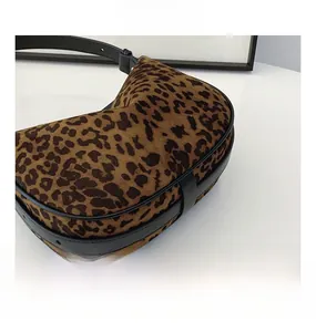 Detailed close-up of retro leopard print crossbody bag with premium plush texture