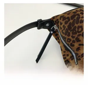 Detail of leopard print fabric with black zipper and high-quality leather puller