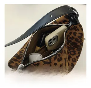 Internal view of leopard print dumpling bag showing phone and lipstick storage space