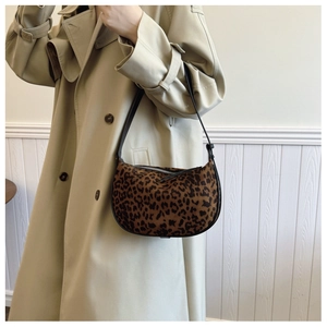 Detail of leopard print hobo bag with velvet texture and black leather shoulder strap