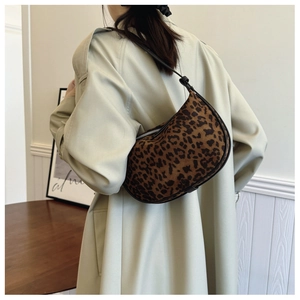 Detail of leopard print hobo bag showing the plush texture and curved half-moon shape