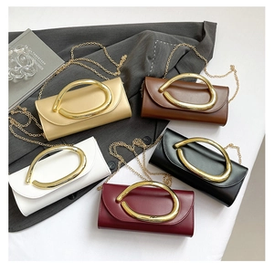Five elegant evening clutch bags in various colors featuring gold oval metal handles and chains