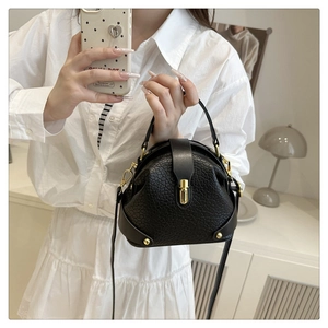 Fashionable black vintage doctor-style crossbody bag with gold hardware and side rivets