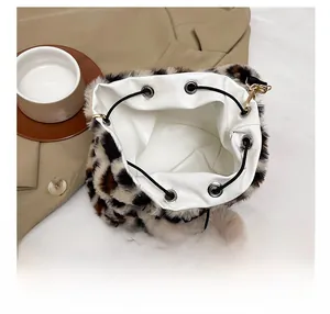 Macro shot of leopard faux fur bucket bag showing spacious interior and drawstring closure