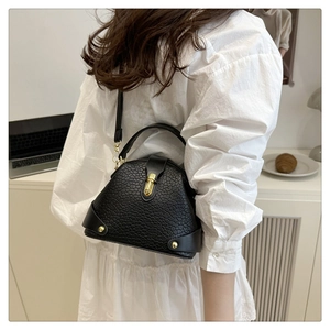 Fashionable black ostrich texture crossbody bag styled with a white pleated outfit