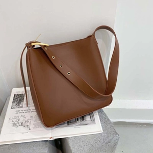 Deep brown leather bucket bag with adjustable shoulder strap for large capacity storage