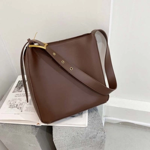Brown minimalist large capacity bucket bag with wide adjustable shoulder strap and gold hardware