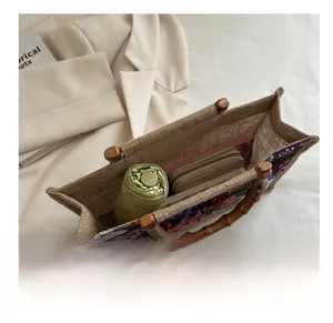 Interior view showing the large storage capacity of the linen handbag with bamboo handle