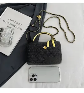 Detailed comparison of quilted chain bag size next to books and a smartphone