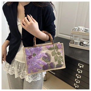 Linen handbag with purple sequin floral embroidery and natural bamboo handle detail