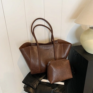 Vintage brown leather tote bag set with interior pouch and embossed fashion lettering