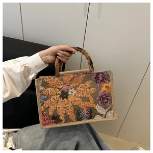 Detailed view of jute handbag featuring bamboo handle and intricate floral sequin embroidery