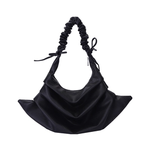 Minimalist black pleated hobo bag with bow handle detail and grainy leather finish