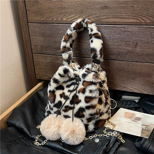 Plush leopard print bucket bag with drawstring pom-poms and gold chain strap