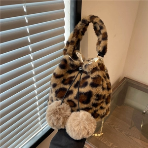 Plush leopard print drawstring bucket bag with fuzzy pom-poms and golden chain strap