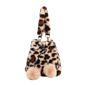 Plush leopard print crossbody bag with drawstring closure and soft pompom details