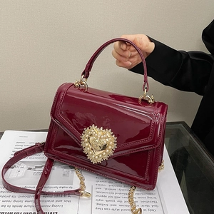 Retro burgundy patent leather crossbody bag with a large golden pearl heart ornament