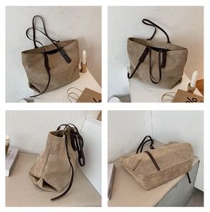 Détails du sac cabas en daim kaki avec coutures contrastées et fines anses marron