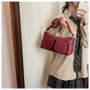 Deep red leather shoulder bag with double front pockets and silver hardware detail