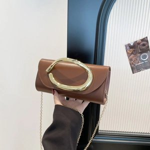Brown leather rectangular clutch with oversized gold oval handle and thin metal chain strap