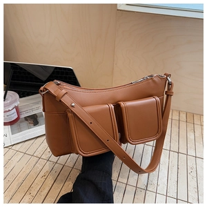 Brown synthetic leather shoulder bag featuring two front flap pockets and adjustable strap