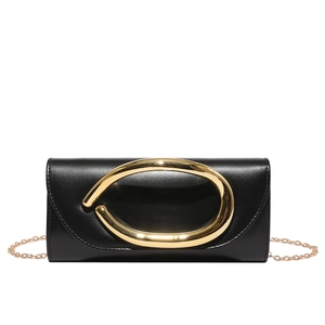 Minimalist black leather clutch bag featuring a prominent gold oval buckle and chain strap