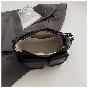 Detail view of the black matte shoulder bag interior showing canvas lining and pockets