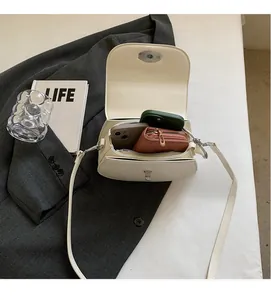Detail of cream saddle bag interior showing large capacity for phones and wallet