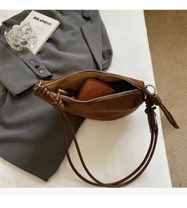 Interior view showing large capacity of the brown suede shoulder bag for daily essentials