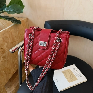 Red quilted leather shoulder bag with silver chain strap and metal lock closure