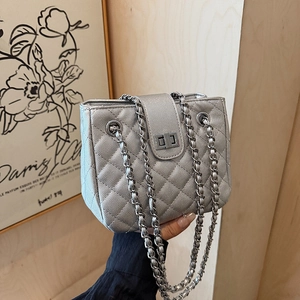 Silver quilted chain bag with metallic finish and adjustable woven shoulder strap