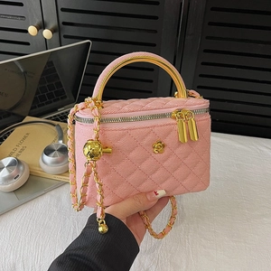 Pink quilted chain crossbody bag with gold camellia logo and metal ring handle