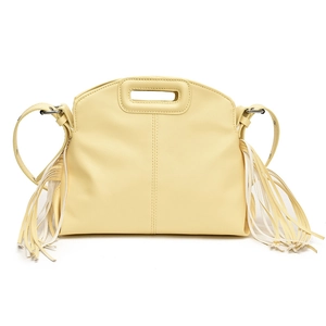 Close-up of yellow PU leather tote with long side tassels and cutout integrated handles