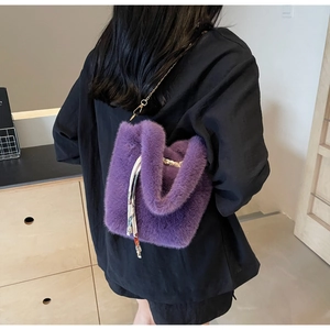 Dettaglio borsa a secchiello in ecopelliccia viola con catena dorata e foulard di seta floreale