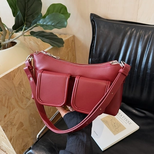 Minimalist wine red leather baguette bag with dual front pockets and silver hardware