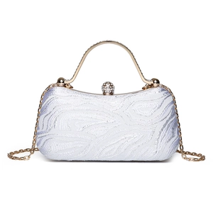 Elegant white evening clutch bag with textured ripple fabric and rhinestone gold handle