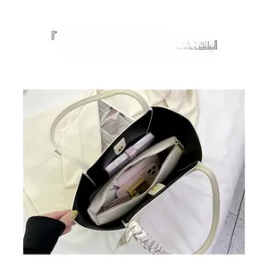 Detail view of large white tote bag interior showing spacious compartments and zip pouch
