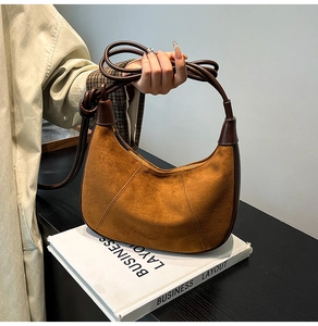 Détail d'un nœud fait main sur un sac hobo en daim marron avec bandoulière