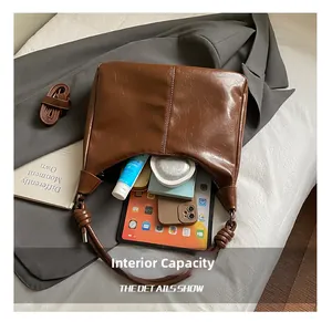 Detail view of brown leather tote bag interior showing large capacity and items