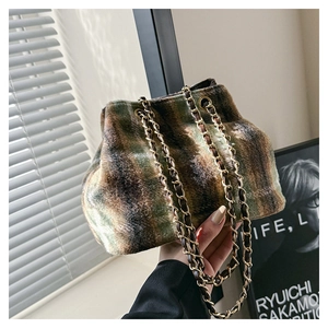Close-up of plush vintage camouflage shoulder bag with gold chain and leather strap