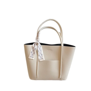 Off-white lychee leather tote bag with a purple fashion scarf on the handle