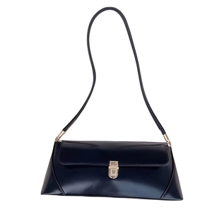 Minimalist navy blue patent leather baguette bag with elegant golden clasp detail