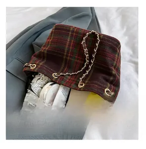 Detail presentation showing the spacious interior of plaid wool tote bag with daily items